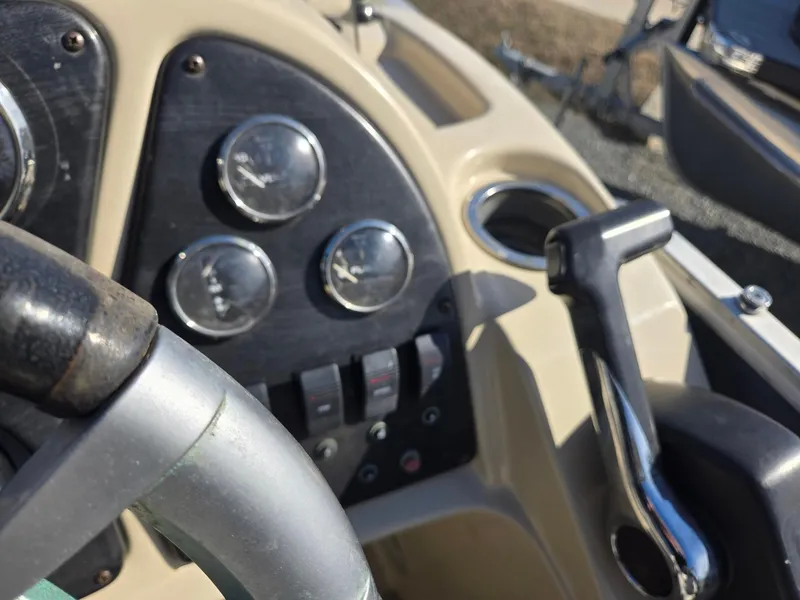 Slide: The Image of Control panel of a 2014 Sweetwater 2086 boat with gauges and throttle lever. - 14
