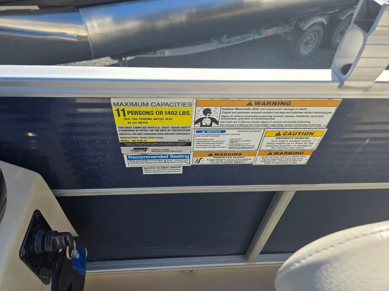 Slide: The Image of 2014 Sweetwater 2086 capacity label, max 11 persons or 1492 lbs, safety warnings visible. - 15