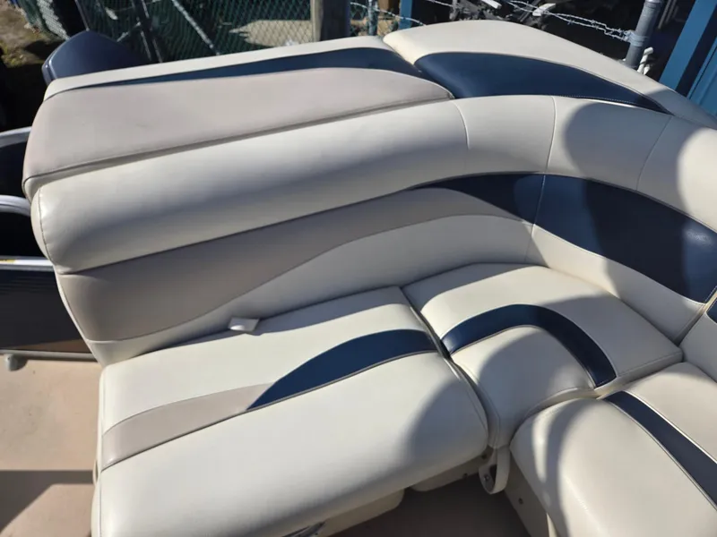 Slide: The Image of Sweetwater 2086 2014 boat seating with beige and navy upholstery. - 16