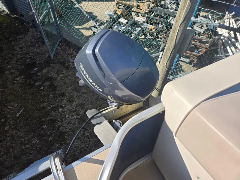 Slide: The Image of 2014 Sweetwater 2086 boat with Yamaha outboard motor, parked near a fence. - 18