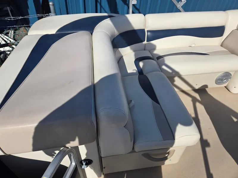 Slide: The Image of 2014 Sweetwater 2086 boat interior with beige and blue cushioned seating. - 19