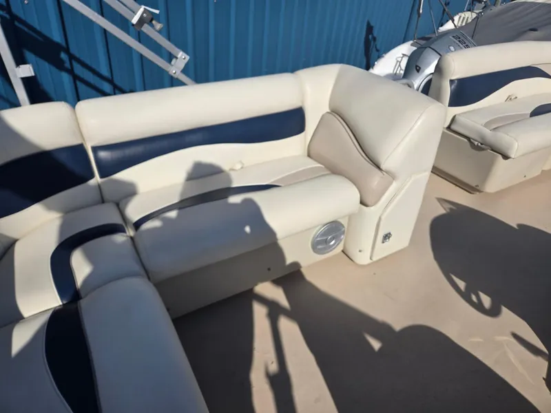 Slide: The Image of 2014 Sweetwater 2086 boat interior with beige and navy seating. - 21
