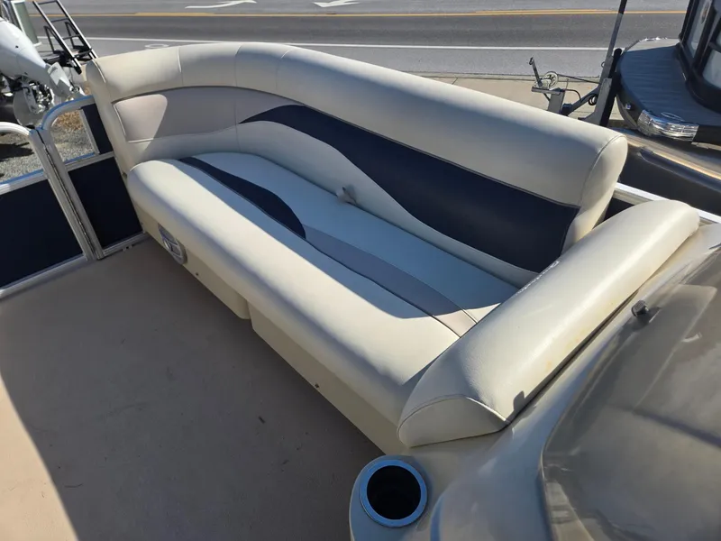 Slide: The Image of 2014 Sweetwater 2086 boat interior with beige and blue cushioned seating. - 24
