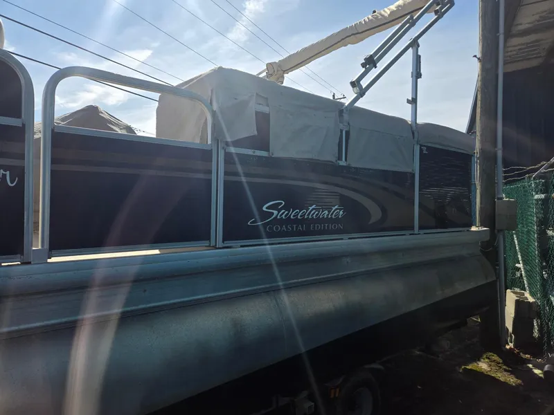 Slide: The Image of 2014 Sweetwater 2086 Coastal Edition pontoon boat with cover, parked outdoors. - 3