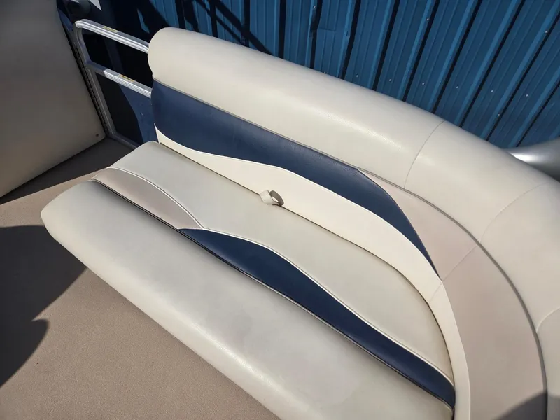 Slide: The Image of Sweetwater 2086 2014 boat seat with blue and white upholstery, against a blue wall. - 8