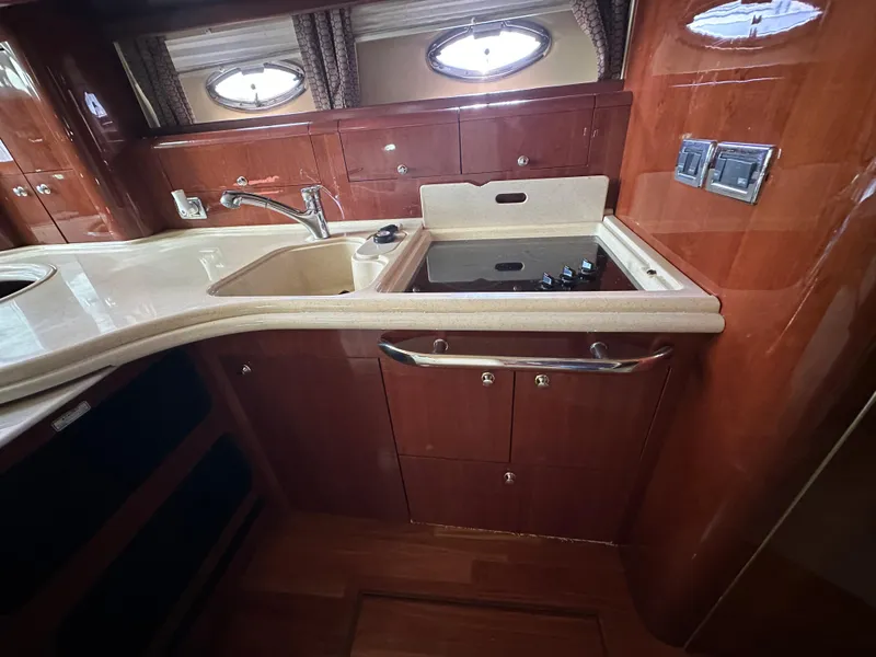 Slide: The Image of Luxurious kitchen area in a 2002 Sea Ray 510 Sundancer yacht with wood cabinetry. - 12