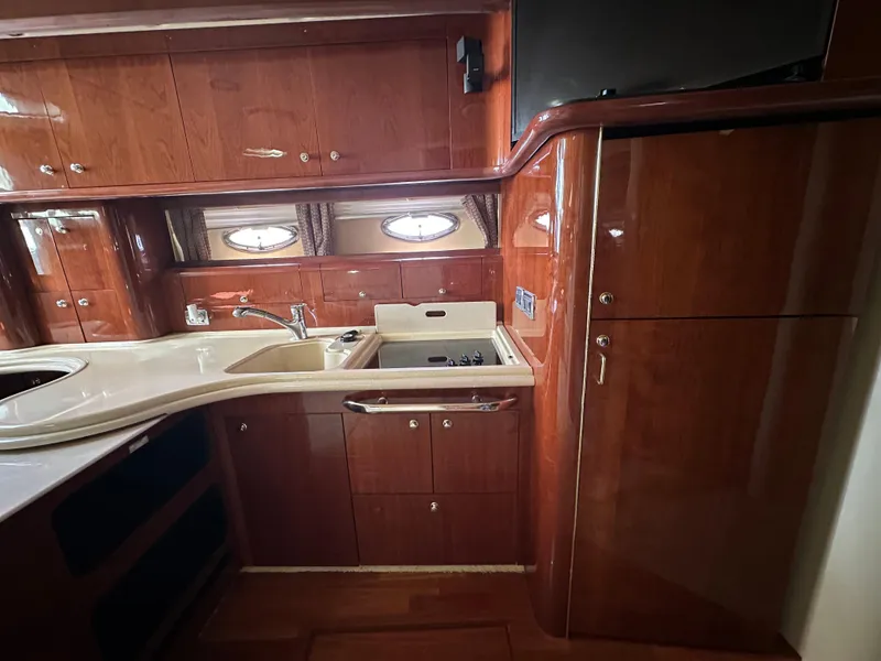 Slide: The Image of Luxurious kitchen interior of 2002 Sea Ray 510 Sundancer yacht with wood cabinetry. - 13