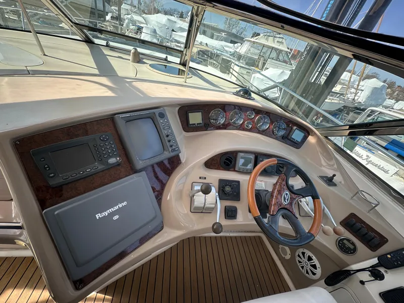 Slide: The Image of Helm of 2002 Sea Ray 510 Sundancer with navigation equipment and wooden steering wheel. - 17