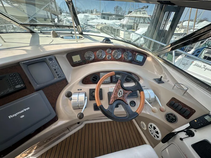 Slide: The Image of Helm of 2002 Sea Ray 510 Sundancer yacht with navigation instruments and wooden steering wheel. - 18