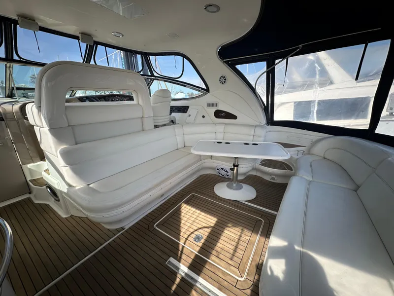 Slide: The Image of Luxurious 2002 Sea Ray 510 Sundancer yacht interior with white seating and wooden flooring. - 2