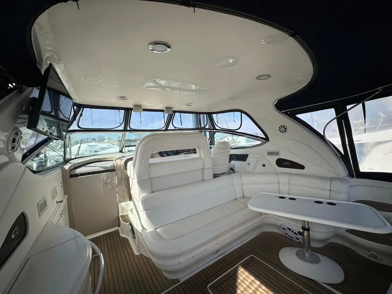 Slide: The Image of Luxurious interior of 2002 Sea Ray 510 Sundancer yacht with white seating and wooden flooring. - 20