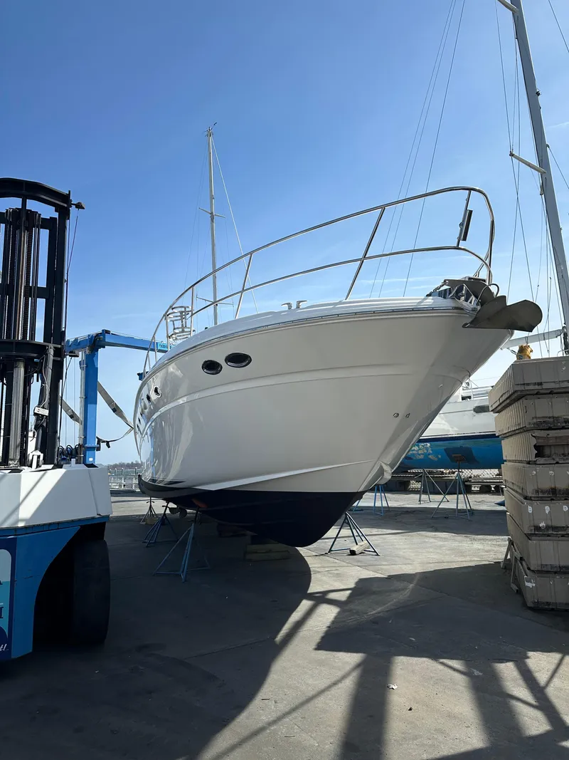 Slide: The Image of 2002 Sea Ray 510 Sundancer yacht on dry dock under clear blue sky. - 22