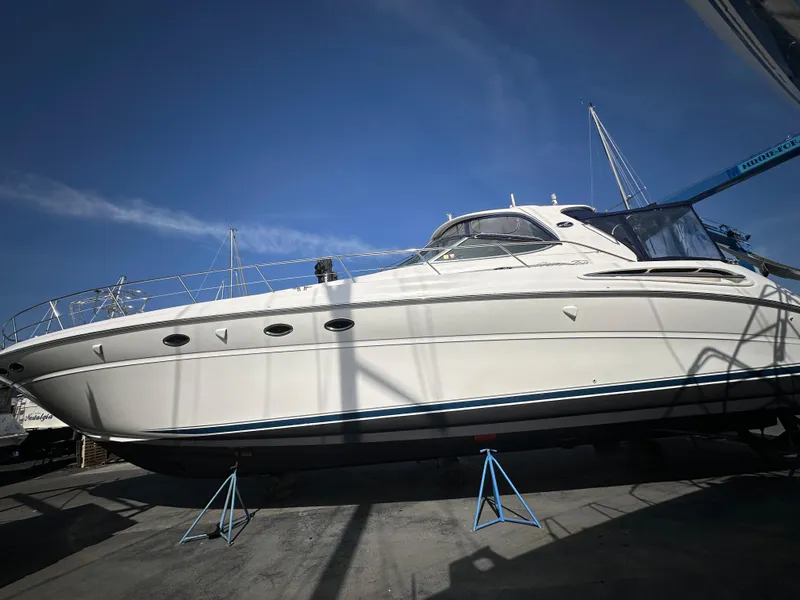 Slide: The Image of 2002 Sea Ray 510 Sundancer yacht on stands under clear blue sky. - 23
