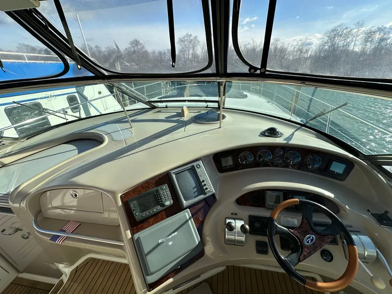 Slide: The Image of 2002 Sea Ray 510 Sundancer helm with navigation equipment and steering wheel. - 3