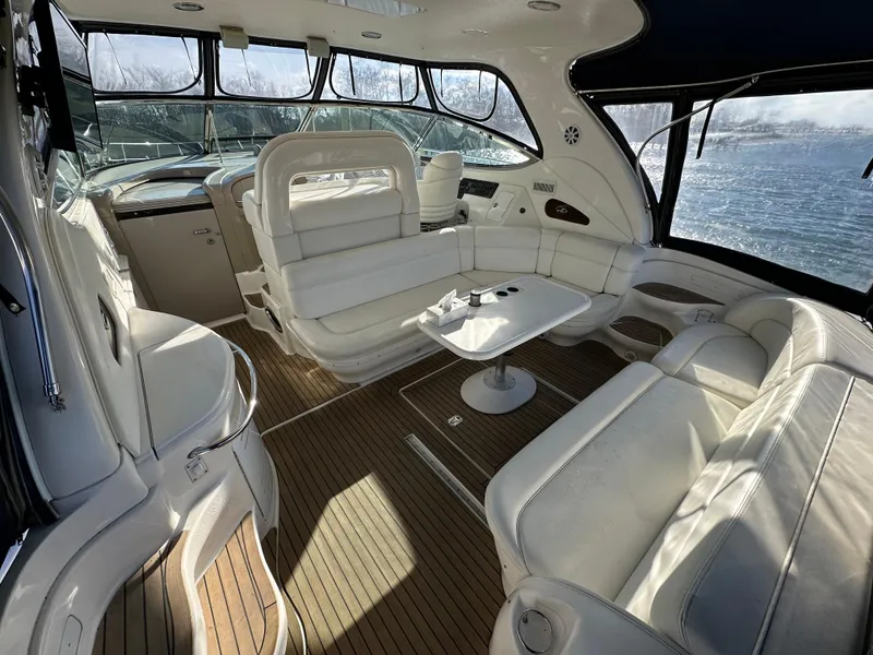 Slide: The Image of Luxurious interior of 2002 Sea Ray 510 Sundancer yacht with white seating and wooden flooring. - 6