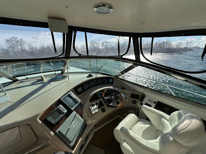 Slide: The Image of Interior view of 2002 Sea Ray 510 Sundancer yacht cockpit with steering wheel and navigation equipment. - 7