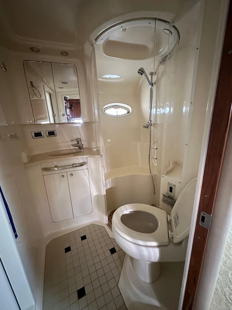 Slide: The Image of Bathroom interior of 2002 Sea Ray 510 Sundancer yacht, featuring shower and toilet. - 8