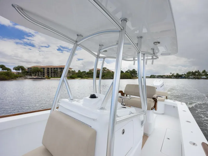 Slide: The Image of 2024 Xcelerator Boatworks 26 on calm water, showcasing sleek design and spacious seating. - 16