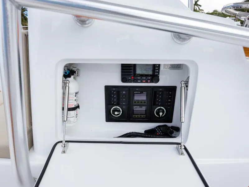 Slide: The Image of Control panel of 2024 Xcelerator Boatworks 26 with fire extinguisher and communication equipment. - 17