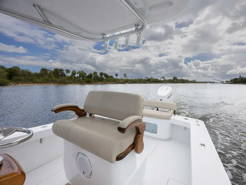 Slide: The Image of 2024 Xcelerator Boatworks 26 on water, featuring comfortable seating and scenic view. - 19
