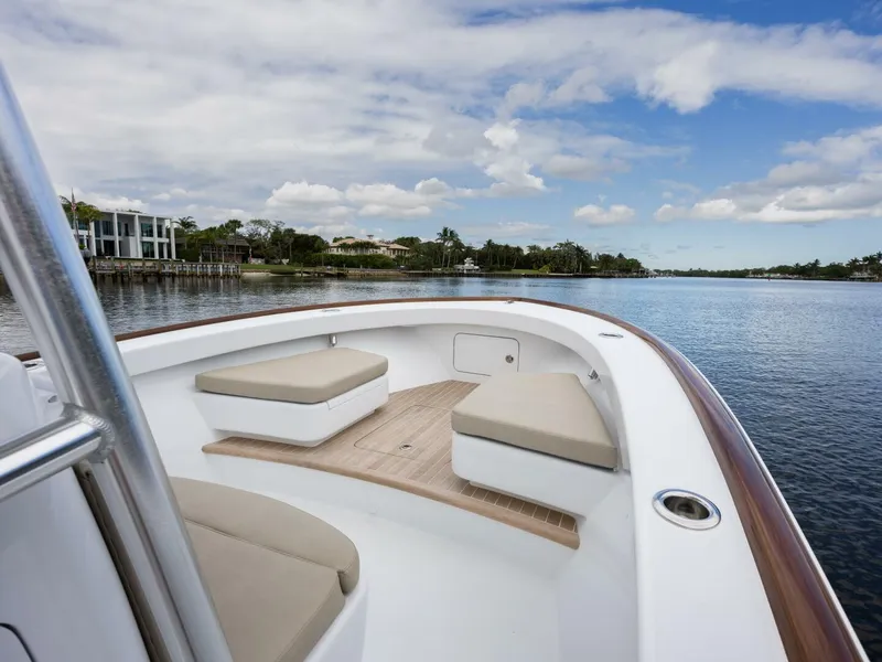 Slide: The Image of 2024 Xcelerator Boatworks 26 on calm water, featuring spacious seating and sleek design. - 23