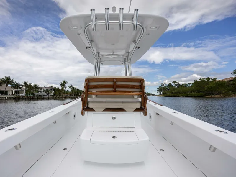 Slide: The Image of 2024 Xcelerator Boatworks 26, sleek design, spacious deck, scenic waterway backdrop. - 27