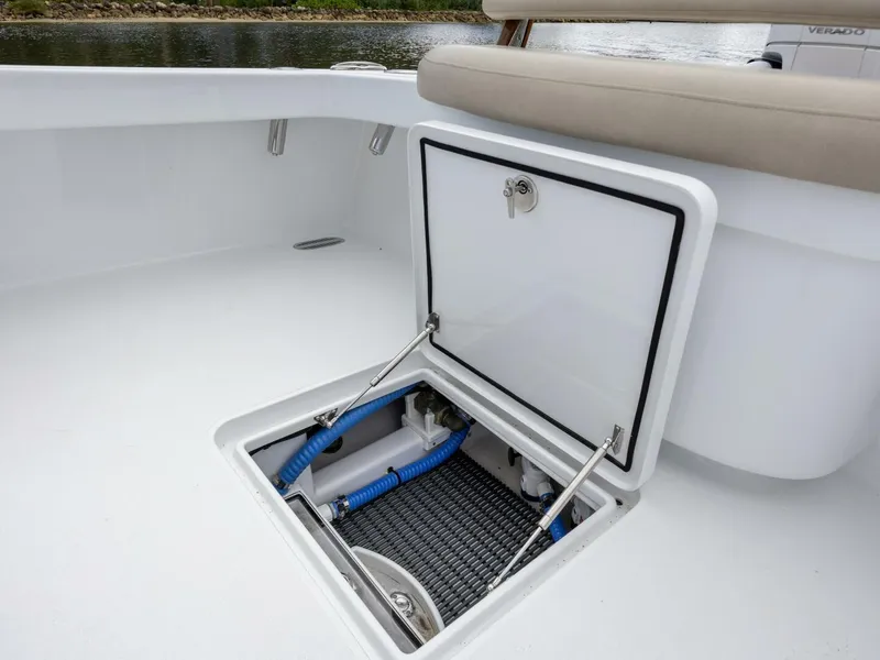 Slide: The Image of 2024 Xcelerator Boatworks 26 with open storage compartment, showcasing interior details. - 31