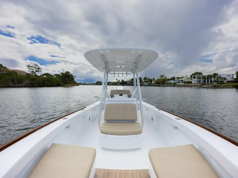 Slide: The Image of 2024 Xcelerator Boatworks 26 on calm water, featuring spacious seating and sleek design. - 9