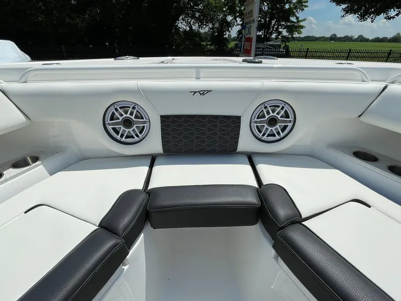 Slide: The Image of 2026 Tidewater 302 CC Adventure boat interior with speakers and cushioned seating. - 11