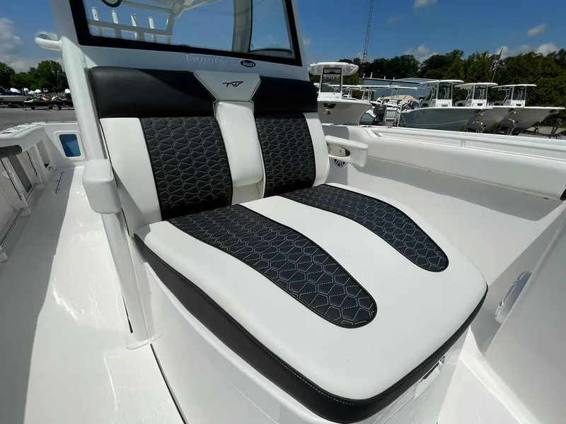 Slide: The Image of 2026 Tidewater 302 CC Adventure boat seat with black and white upholstery, outdoor setting. - 15