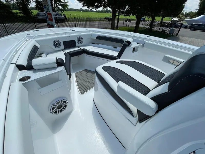 Slide: The Image of 2026 Tidewater 302 CC Adventure boat interior with cushioned seating and speakers. - 16