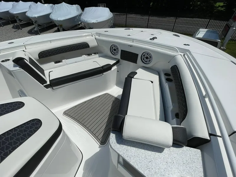 Slide: The Image of 2026 Tidewater 302 CC Adventure boat interior with cushioned seating and modern design. - 17