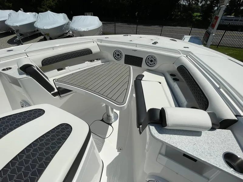 Slide: The Image of 2026 Tidewater 302 CC Adventure boat interior with seating and table. - 18