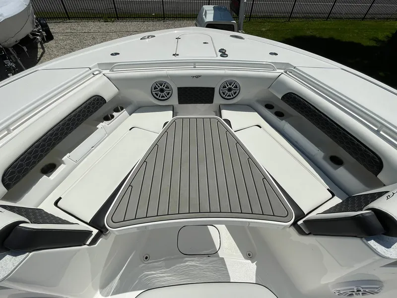 Slide: The Image of 2026 Tidewater 302 CC Adventure boat interior with cushioned seating and speakers. - 19