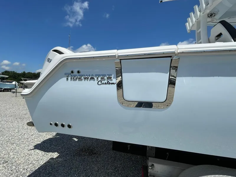 Slide: The Image of 2026 Tidewater 302 CC Adventure boat, white hull, outdoor display, sunny day. - 2
