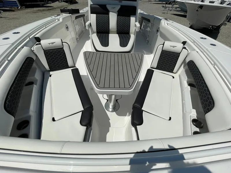 Slide: The Image of 2026 Tidewater 302 CC Adventure boat interior with seating and table. - 20