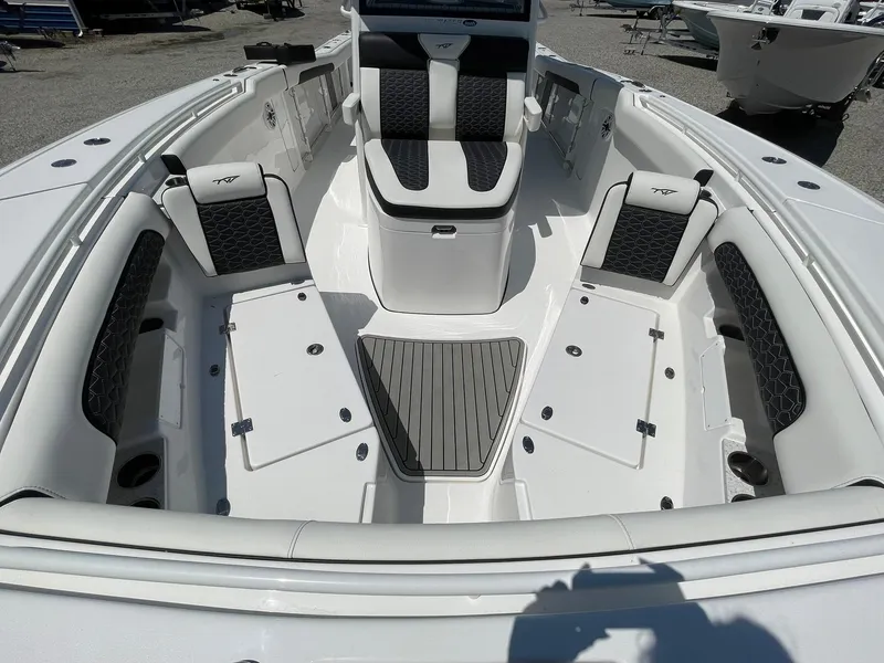 Slide: The Image of 2026 Tidewater 302 CC Adventure boat interior with cushioned seating and storage compartments. - 21