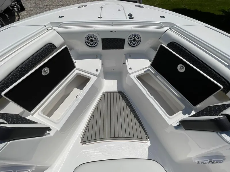Slide: The Image of 2026 Tidewater 302 CC Adventure boat interior with open storage compartments and sleek design. - 22