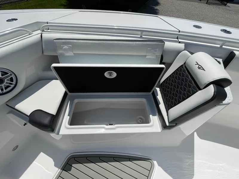 Slide: The Image of 2026 Tidewater 302 CC Adventure boat interior with open storage compartment and cushioned seating. - 23