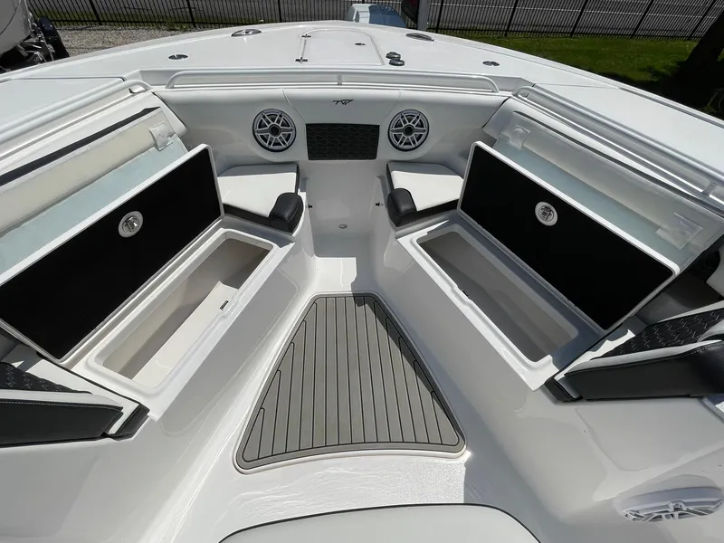 Slide: The Image of 2026 Tidewater 302 CC Adventure boat interior with open storage compartments and seating. - 25