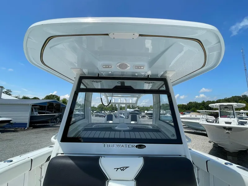 Slide: The Image of 2026 Tidewater 302 CC Adventure boat, sleek design, docked under clear blue sky. - 28
