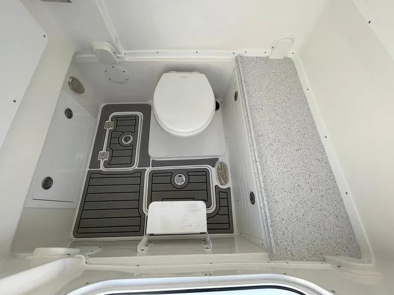 Slide: The Image of 2026 Tidewater 302 CC Adventure boat interior with toilet and non-slip flooring. - 31