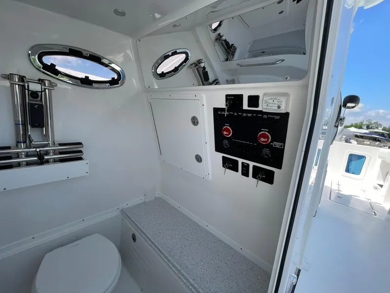 Slide: The Image of Interior of 2026 Tidewater 302 CC Adventure boat, featuring control panel and portholes. - 32