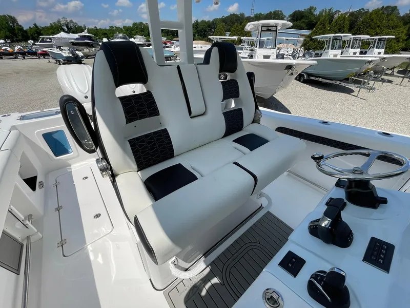 Slide: The Image of 2026 Tidewater 302 CC Adventure boat interior with dual seats and steering console. - 42
