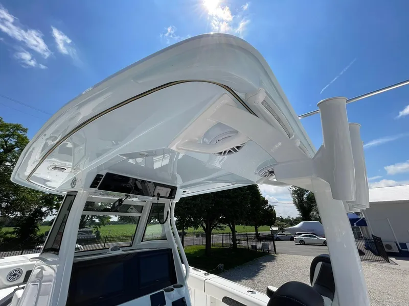 Slide: The Image of 2026 Tidewater 302 CC Adventure boat helm under sunny sky. - 46