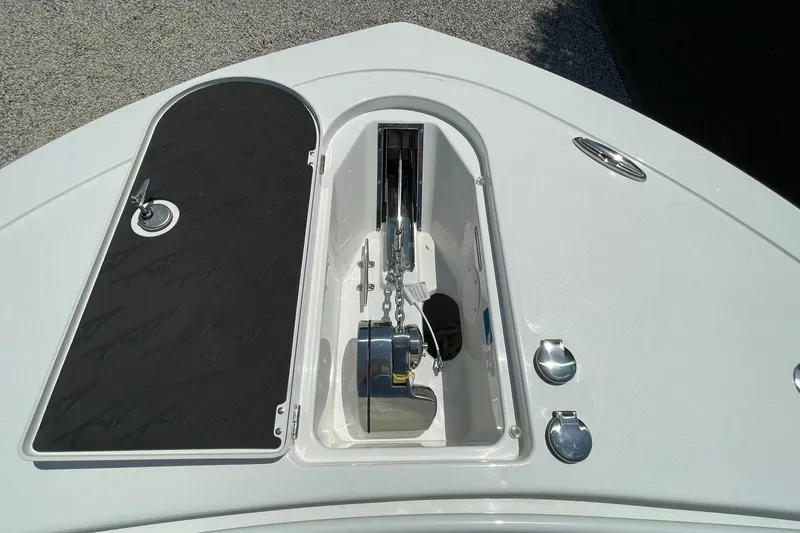Slide: The Image of 2026 Tidewater 302 CC Adventure boat anchor compartment with chain and storage. - 6