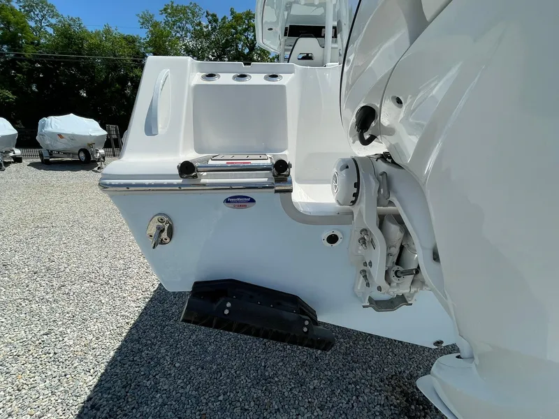 Slide: The Image of 2026 Tidewater 302 CC Adventure boat rear view with engine details. - 69