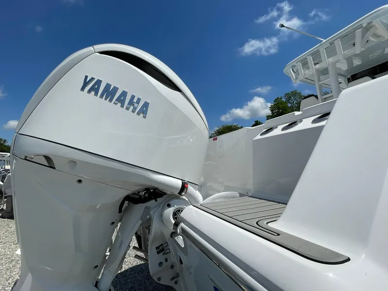 Slide: The Image of 2026 Tidewater 302 CC Adventure boat with Yamaha outboard motor under clear blue sky. - 72