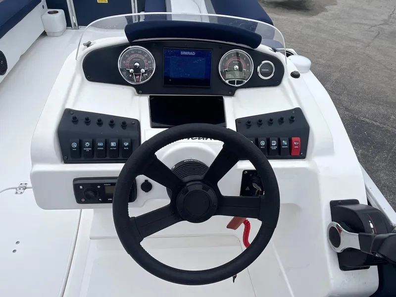 Slide: The Image of 2021 Hurricane FD236 OB boat dashboard with steering wheel and control panel. - 5