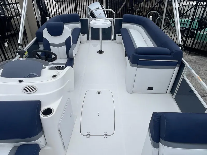 Slide: The Image of 2021 Hurricane FD236 OB boat interior with blue and white seating and a central table. - 8